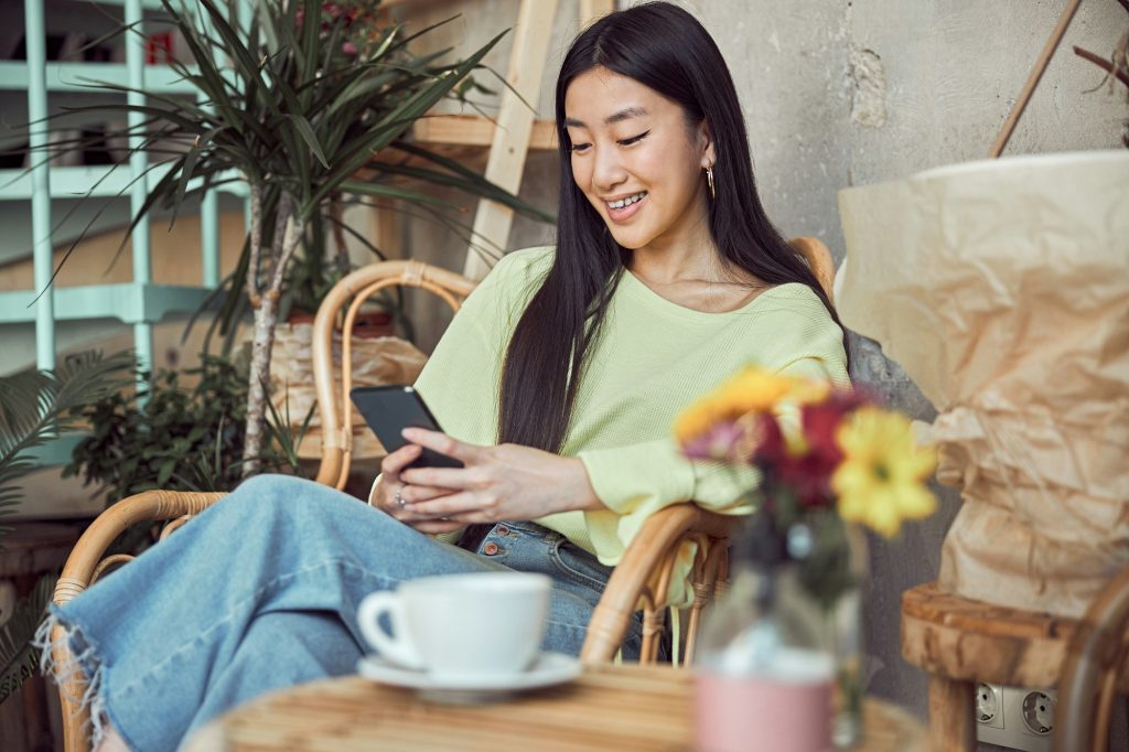 Photo of Asian woman relaxing in cafe